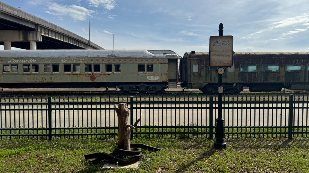 Two old trains and an example of Sherman's neckties - bent metal - in Meridian, Mississippi