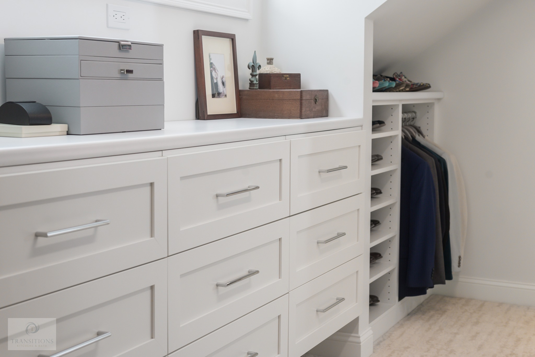 Walk-in closet with white shaker cabinetry, open shelving, and drawer storage.