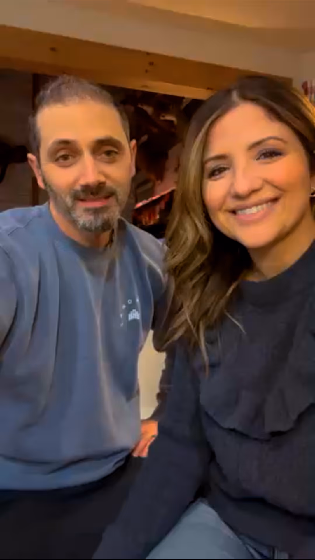Man and woman sitting together smiling at church or hospital event with friendly faces.