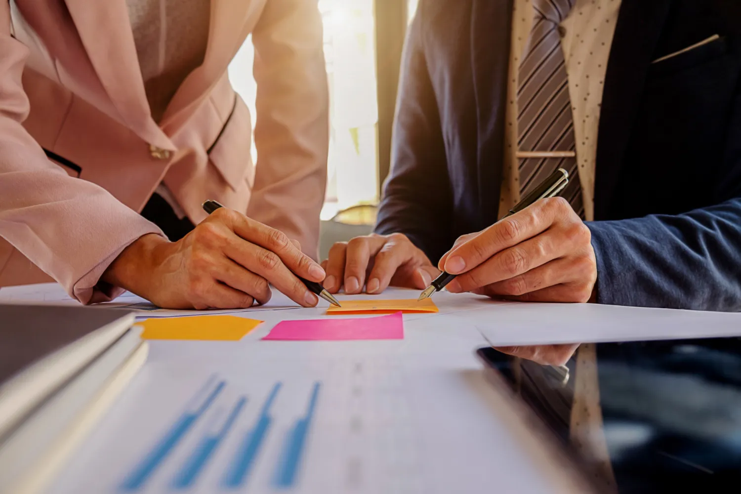 Business colleagues reviewing financial documents and graphs together