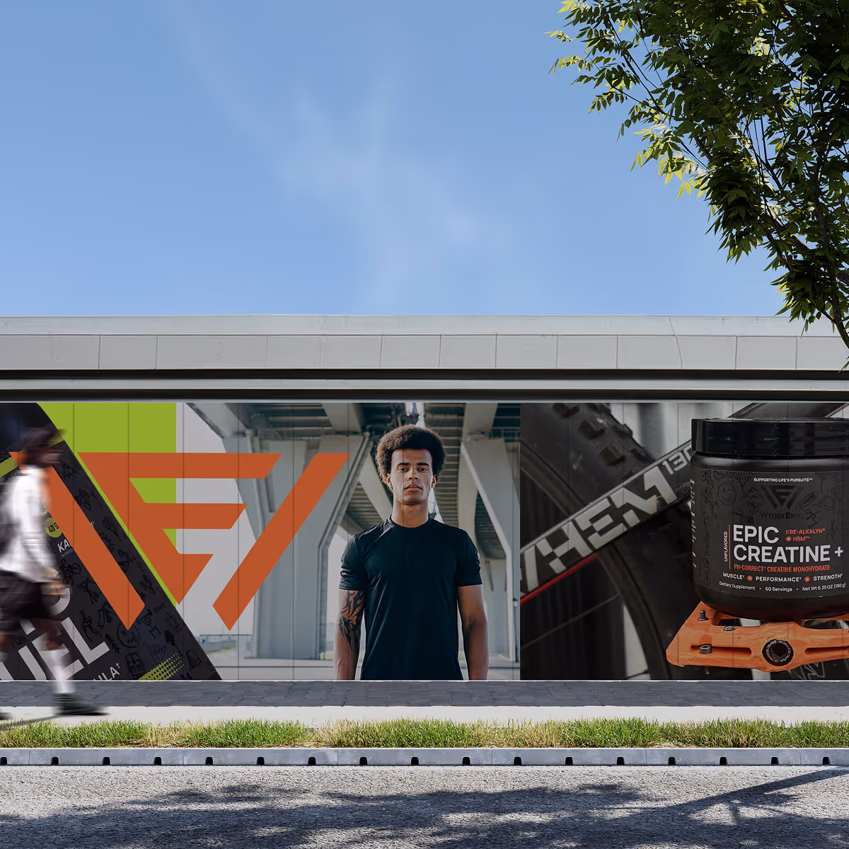 Street advertisement featuring a man in a black shirt with an abstract orange logo on the left and a black container of Epic Creatine+ supplement on the right.
