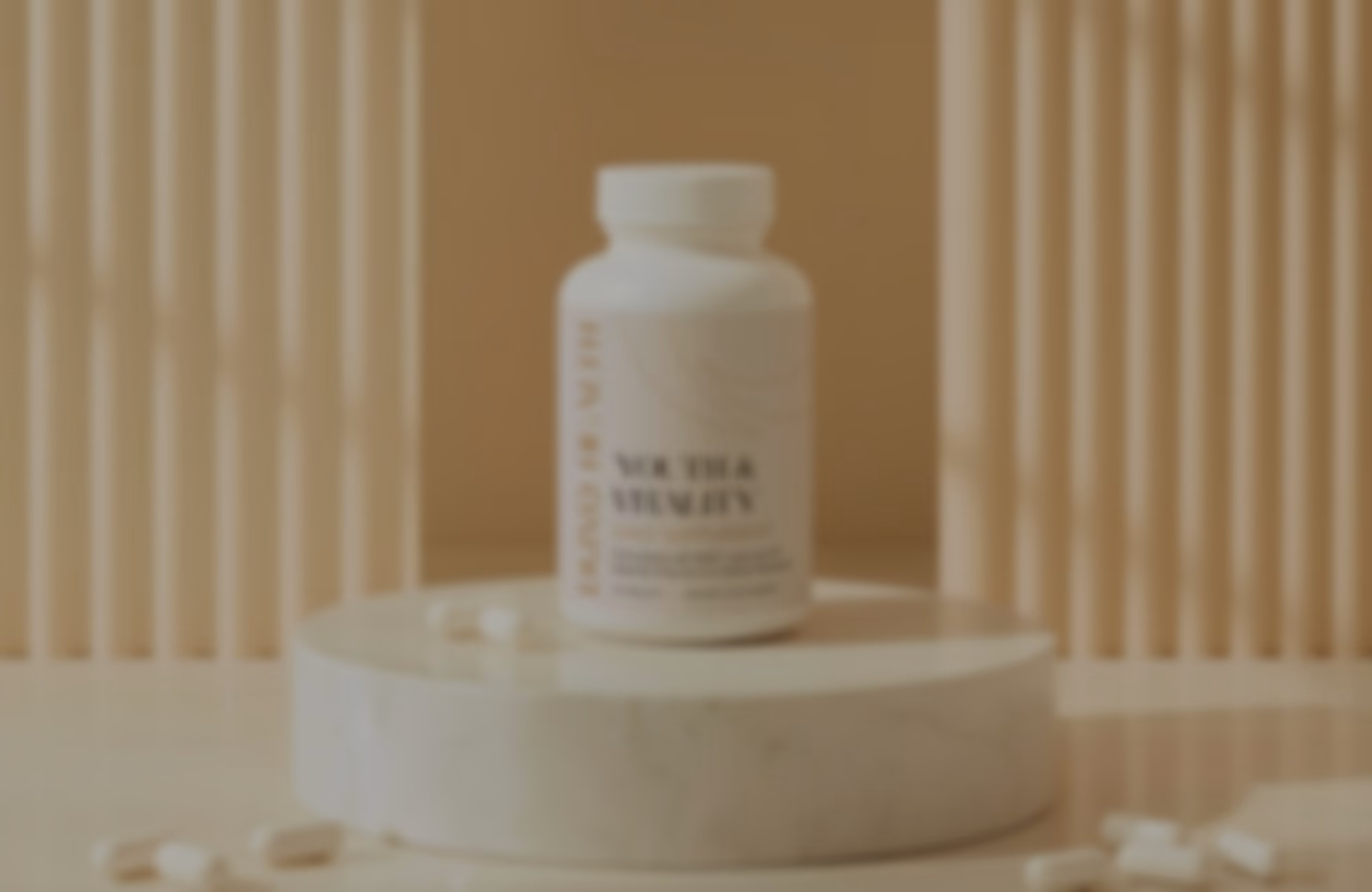 White pill bottle with blurred label placed on a round marble platform with scattered pills around it, set against a beige background with vertical slats.