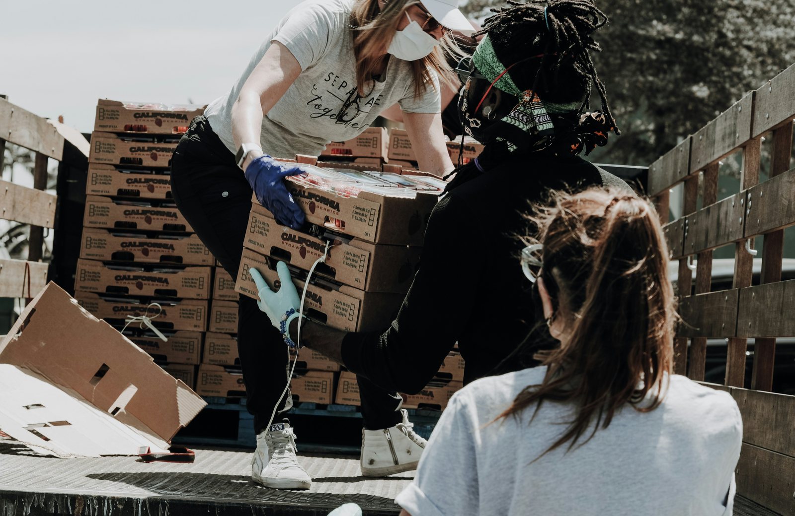 Volunteers unloading boxes of food from a truck