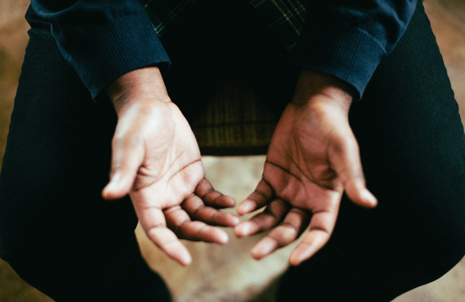 Open hands resting in a lap