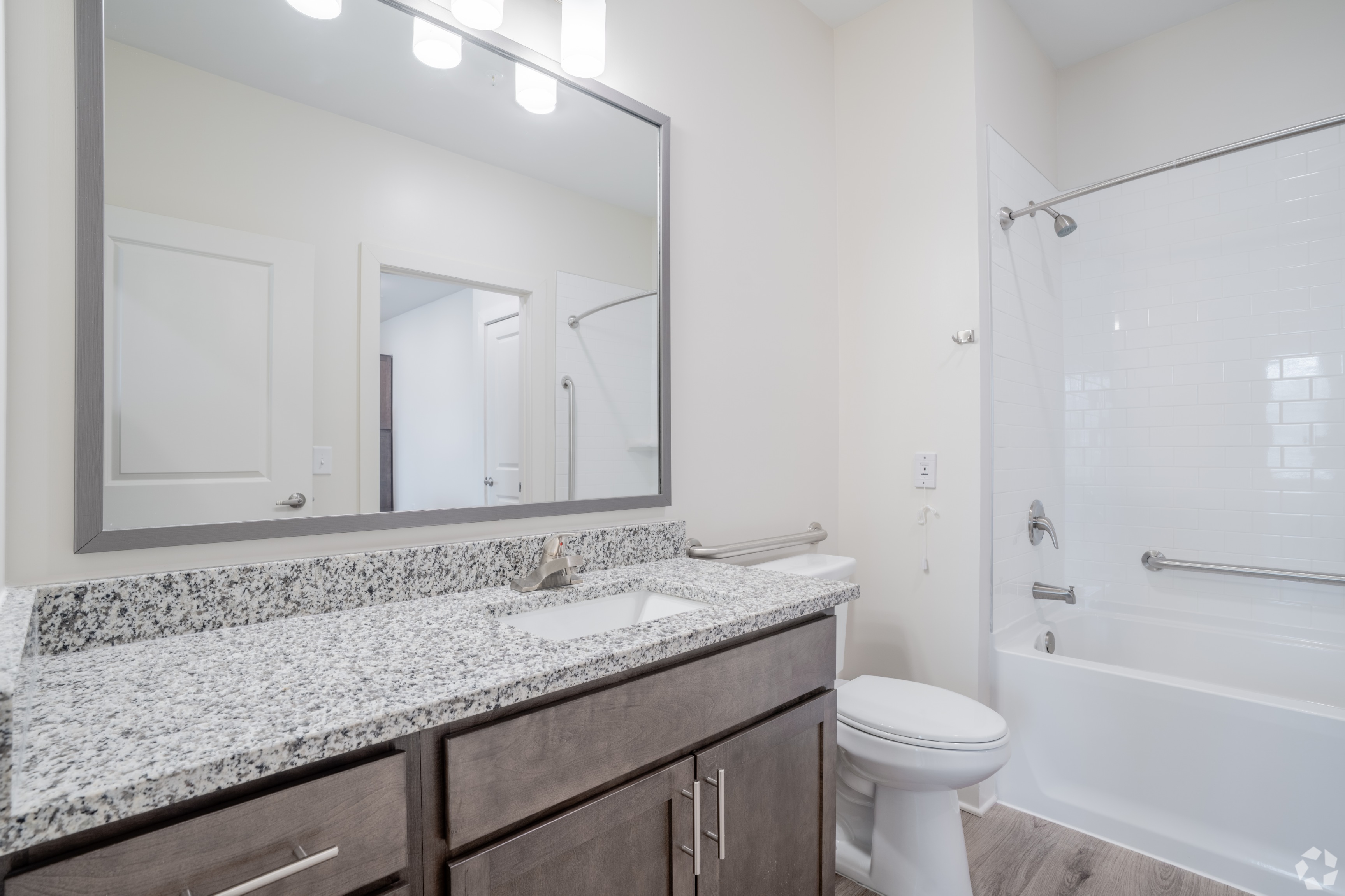 Bathroom with view of vanity, mirror, toilet and tub/shower combo