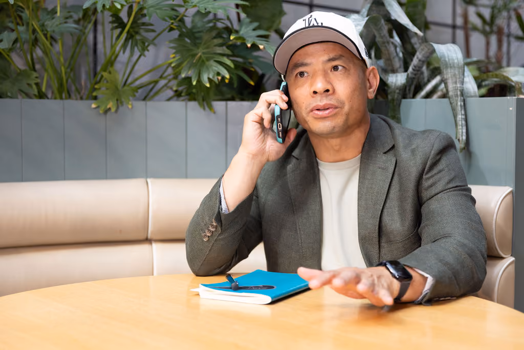 Lino, the Melbourne Career coach talking on the phone.