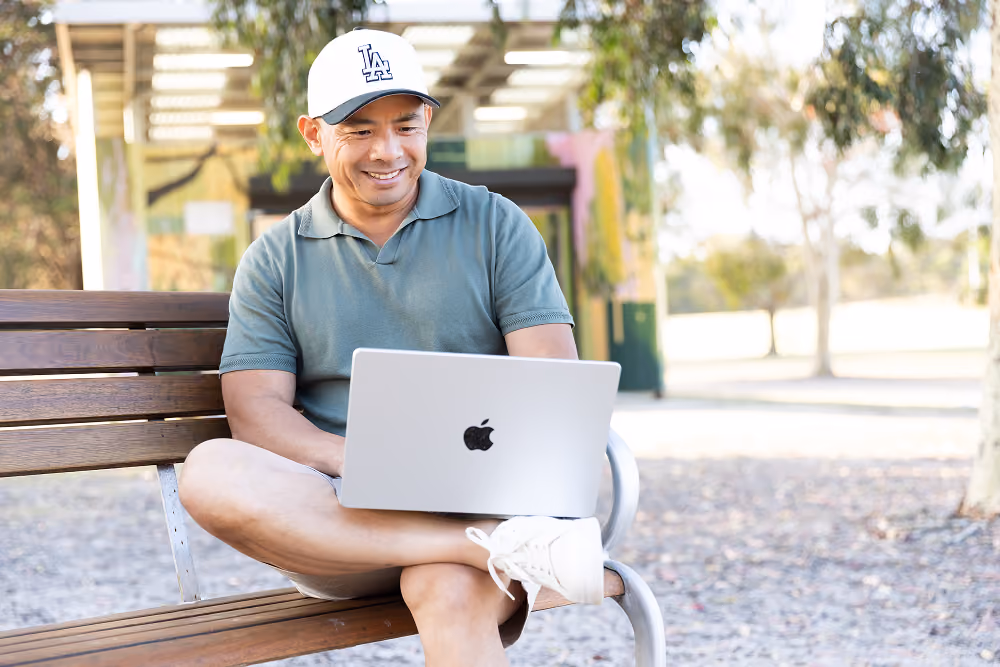 Lino Pun, a Melbourne Business Mentor is reading emails from his laptop.