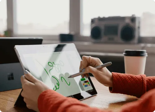 Professional reviewing charts and graphs on a laptop