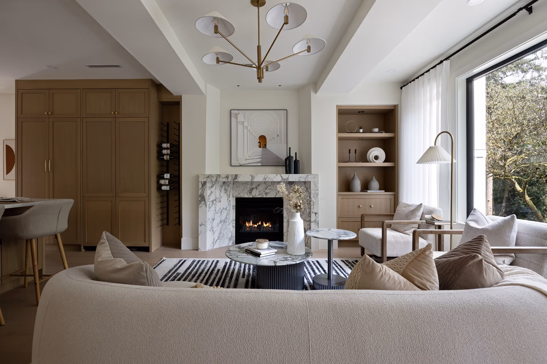 Modern living room interior with fireplace, large windows and natural light