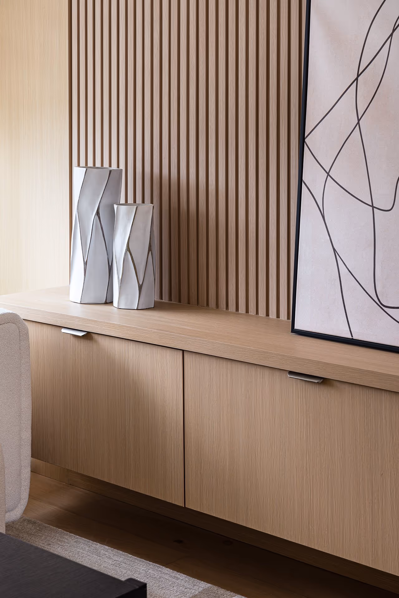Modern interior detail with wood paneling, cabinetry and natural light
