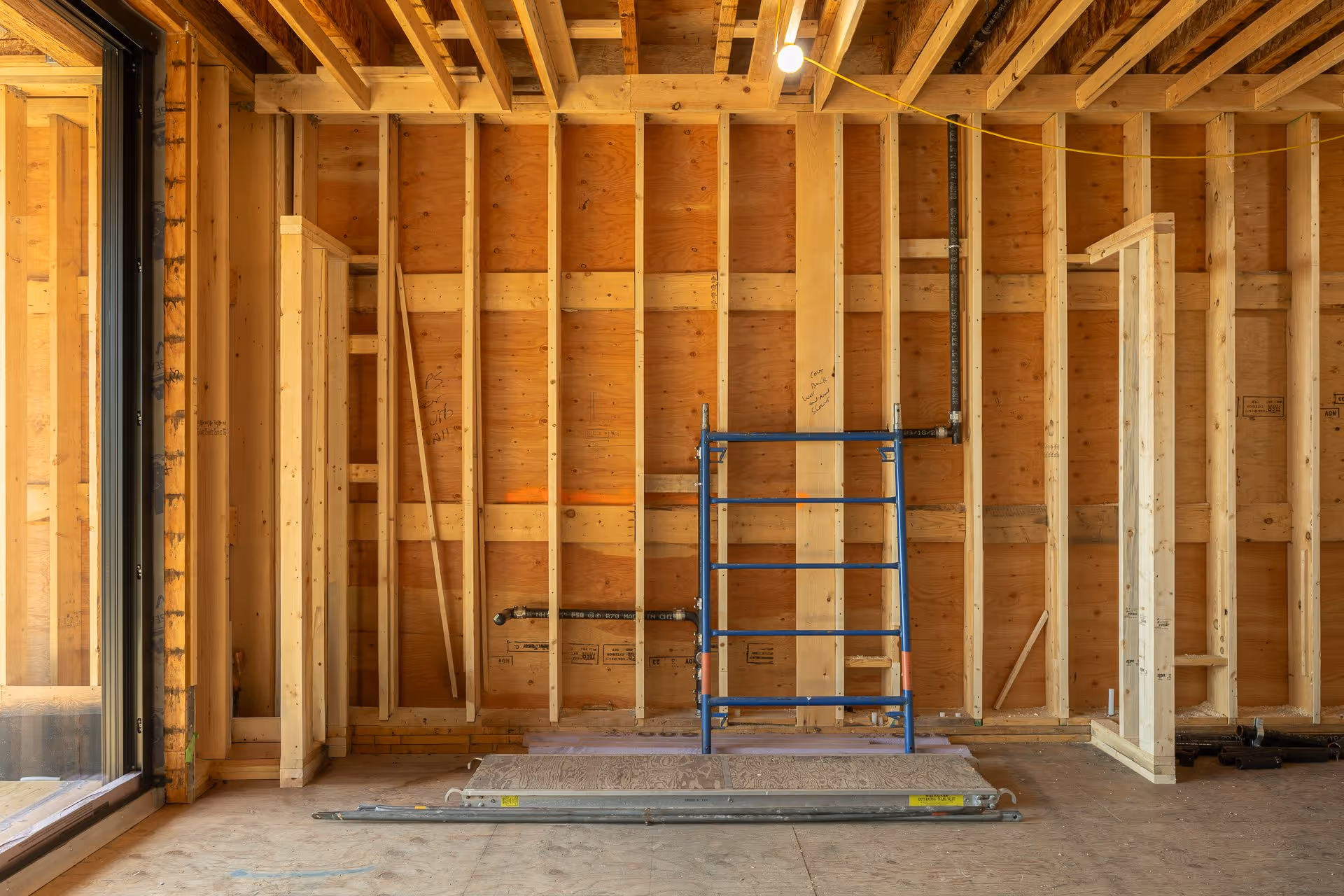 Residential construction interior with wood framing and natural light
