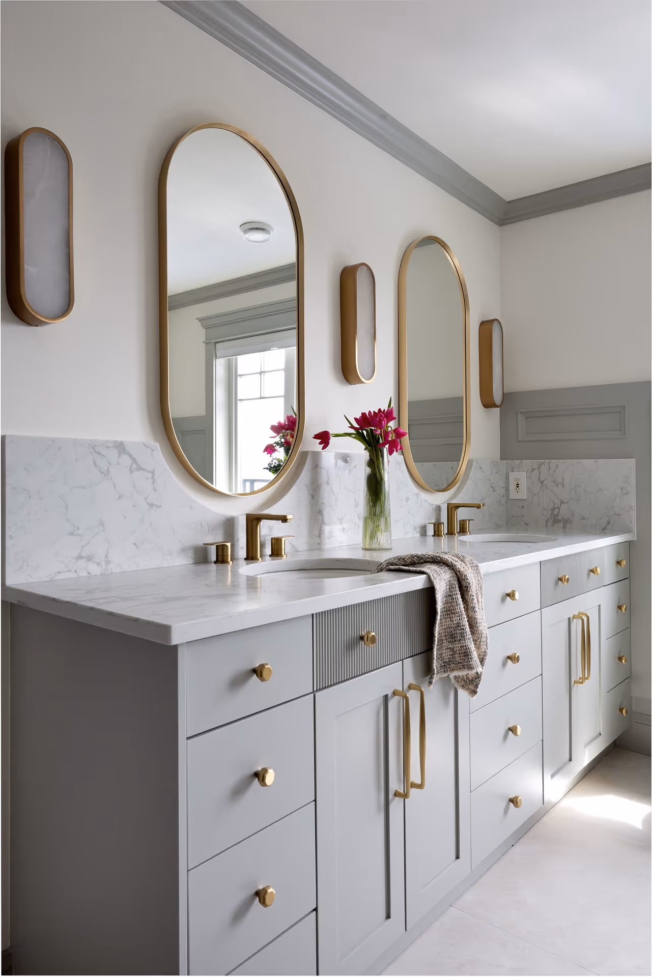 Modern bathroom vanity with double sinks, brass fixtures, and marble countertop, interior design photography