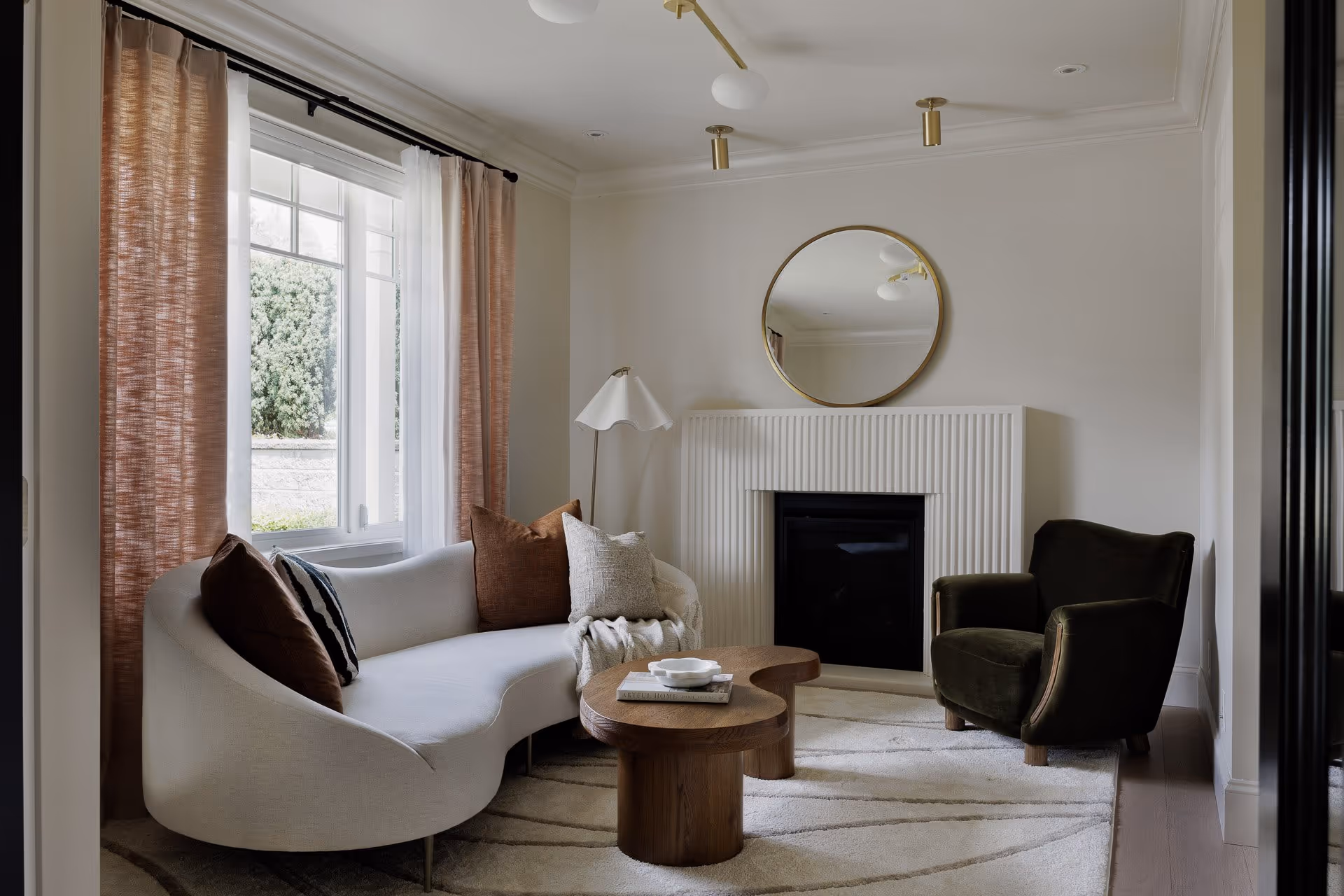 Cozy living room with fireplace, neutral tones, and natural light, residential interior photography