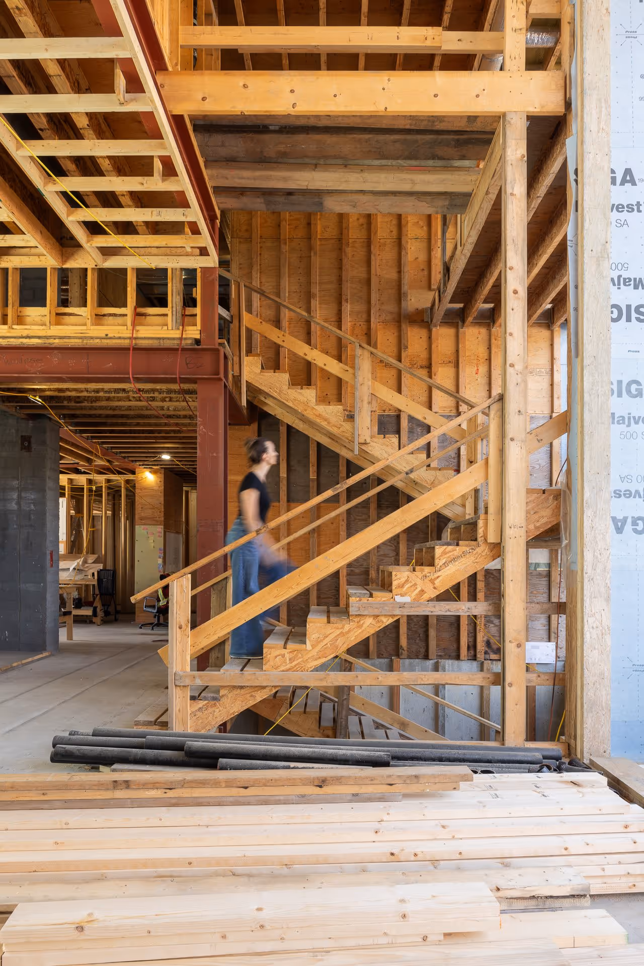 Construction site interior with wooden framing and staircase structure, Vancouver construction photography