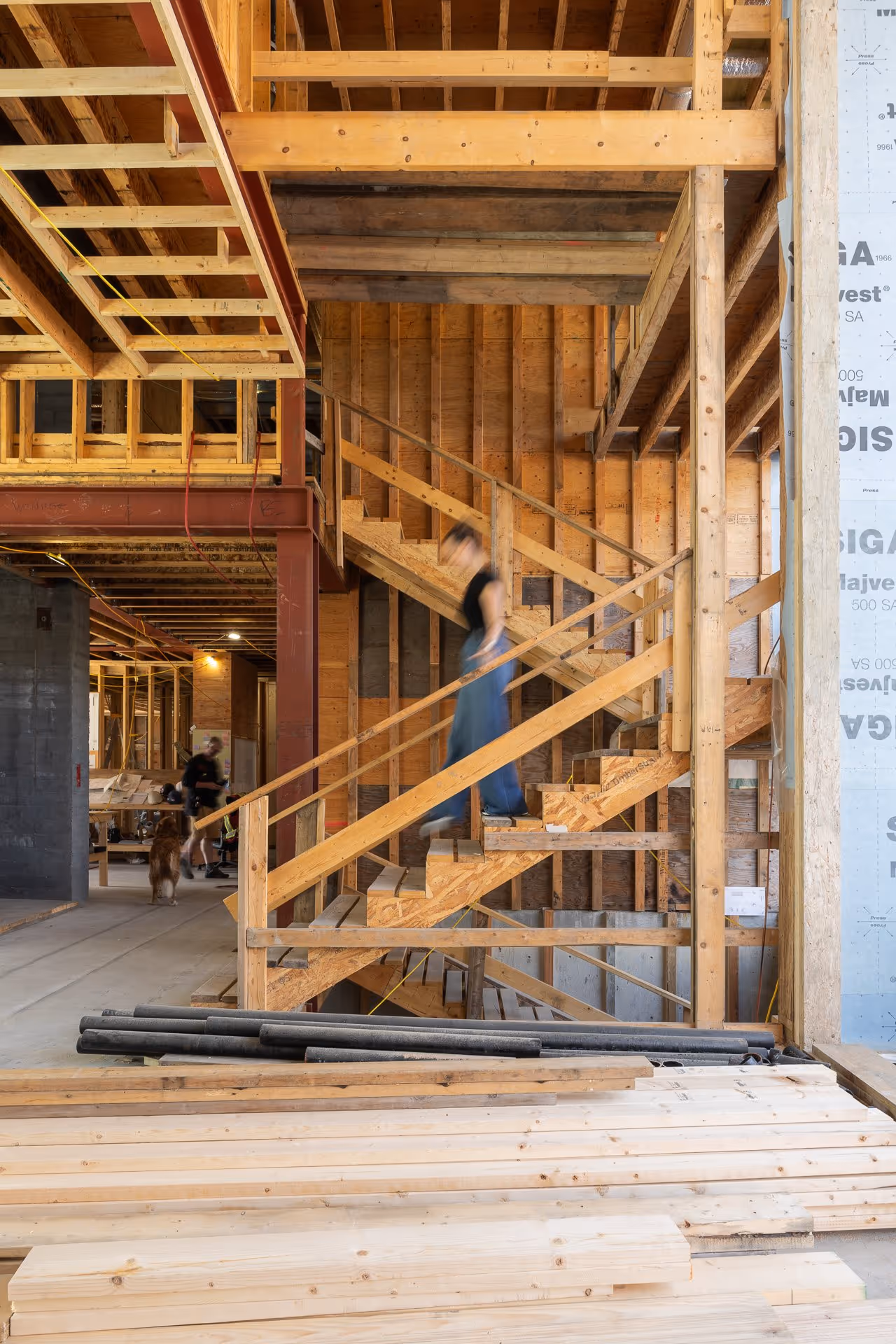 Construction site interior with wooden framing and staircase structure, Vancouver construction photography