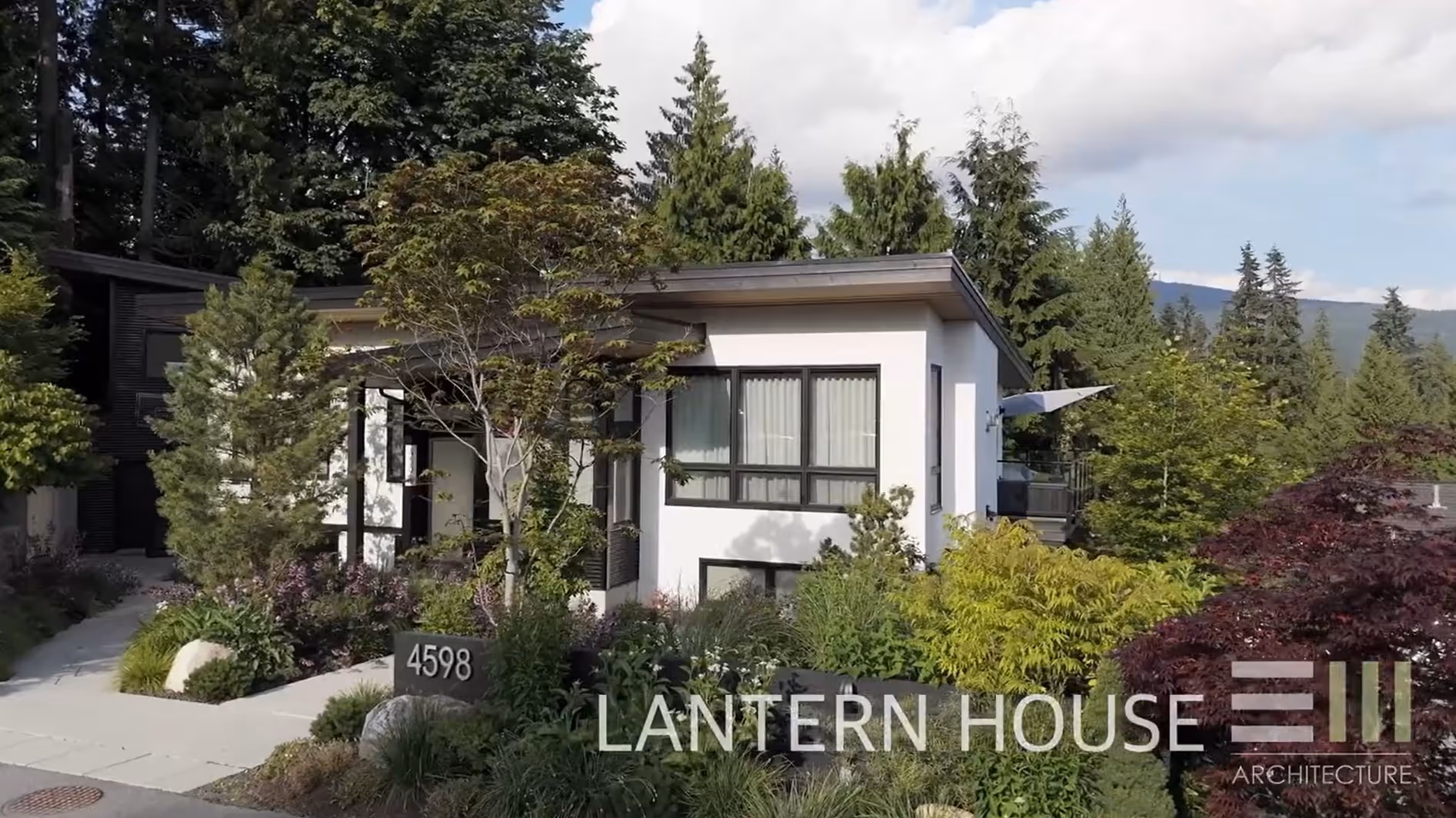 Modern house exterior with landscaped garden and mountain backdrop, North Vancouver architectural videography