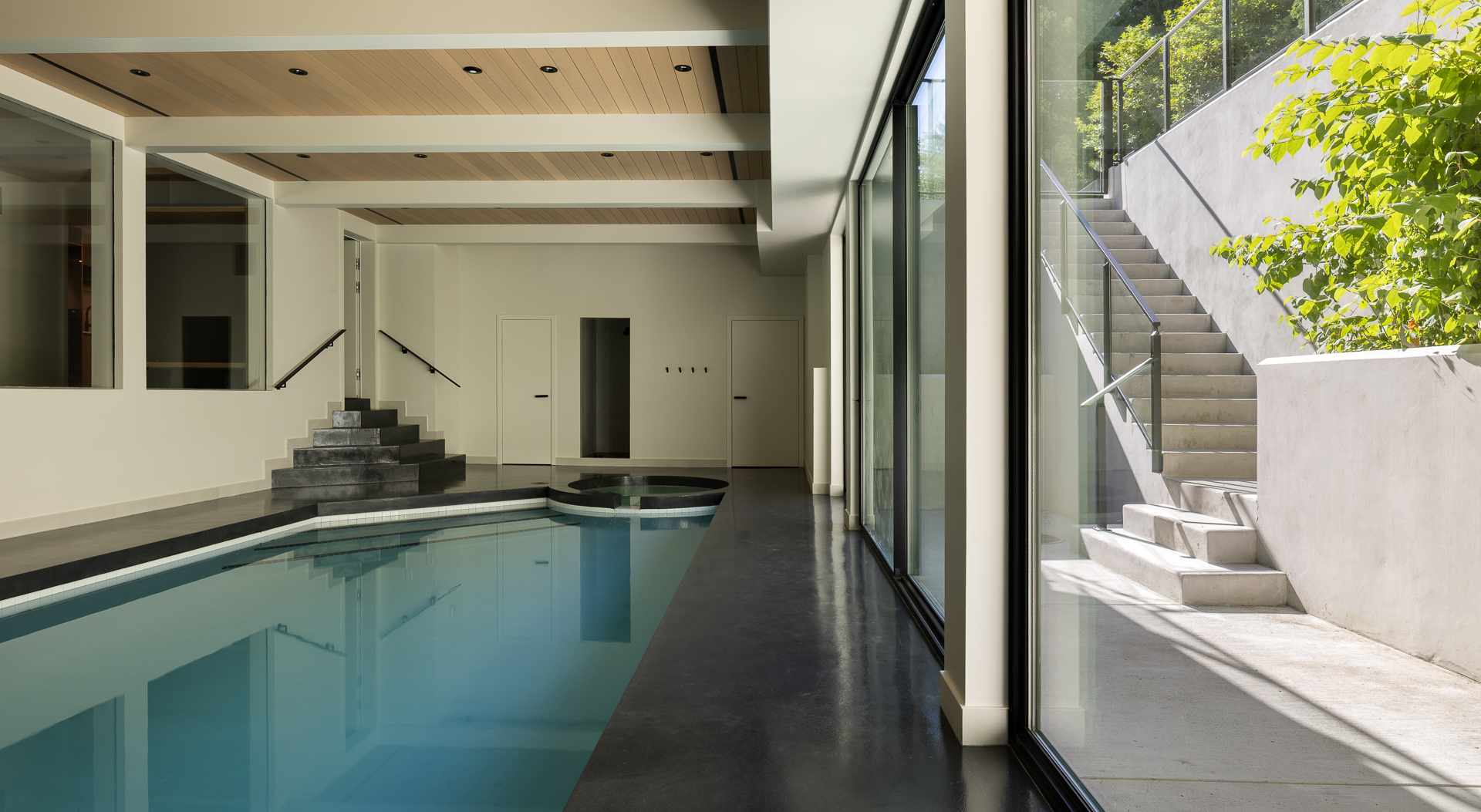Indoor pool with wood-slat ceiling and full-height glazing, The Oku House, West Vancouver — architectural photography by Iryna Avilova, DeLight Media