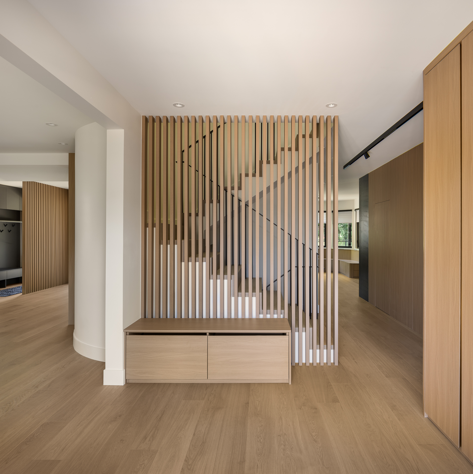 The Oku House entrance staircase framed by a slatted wood screen, Japandy minimalist interior in Vancouver