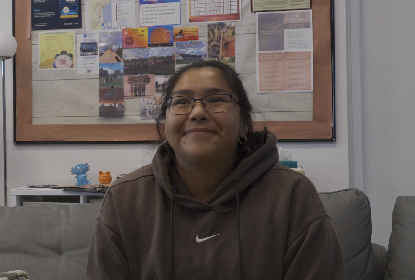 Photo of Dani Desmoulin smiling in a brown sweater