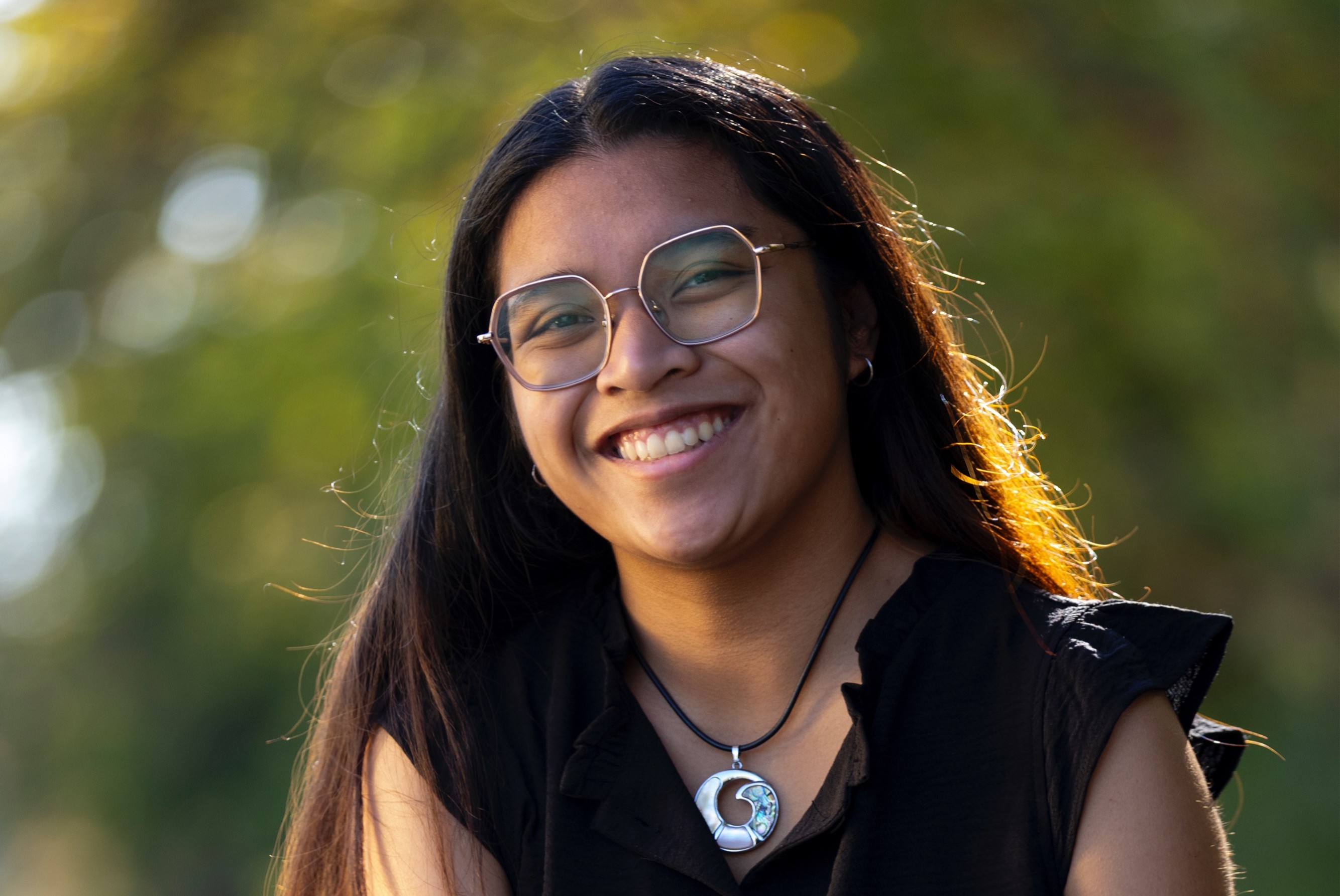 Photo of Danicka Villavivenxio in a black shirt and silver circular necklace.