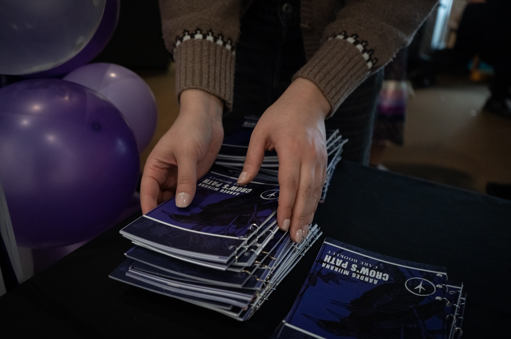 Hands placing the care booklets on the table