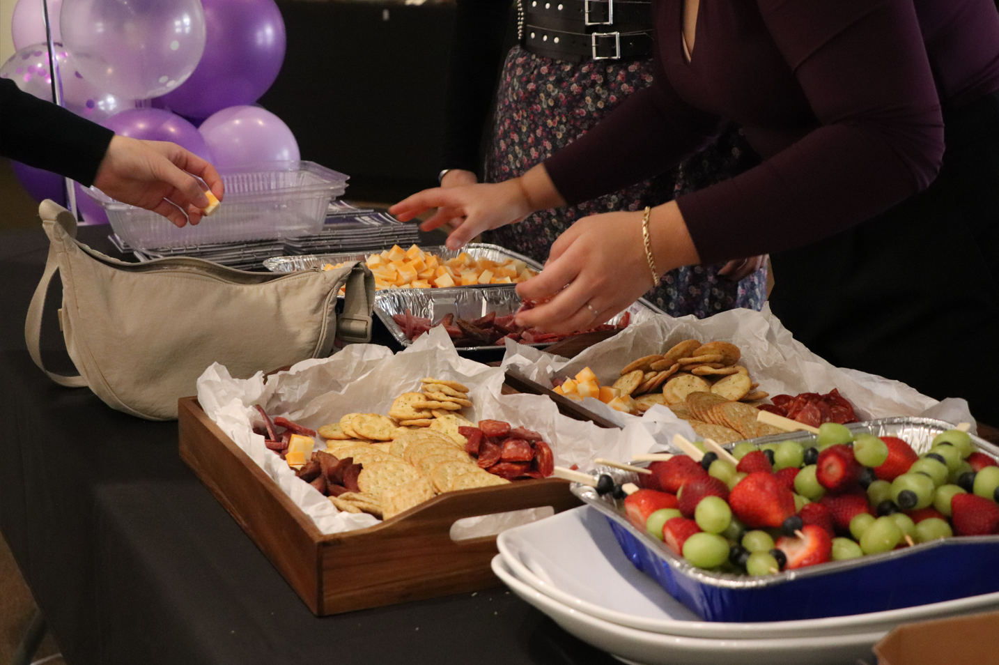 The food spread on the table, with fruit and a charcuterie board
