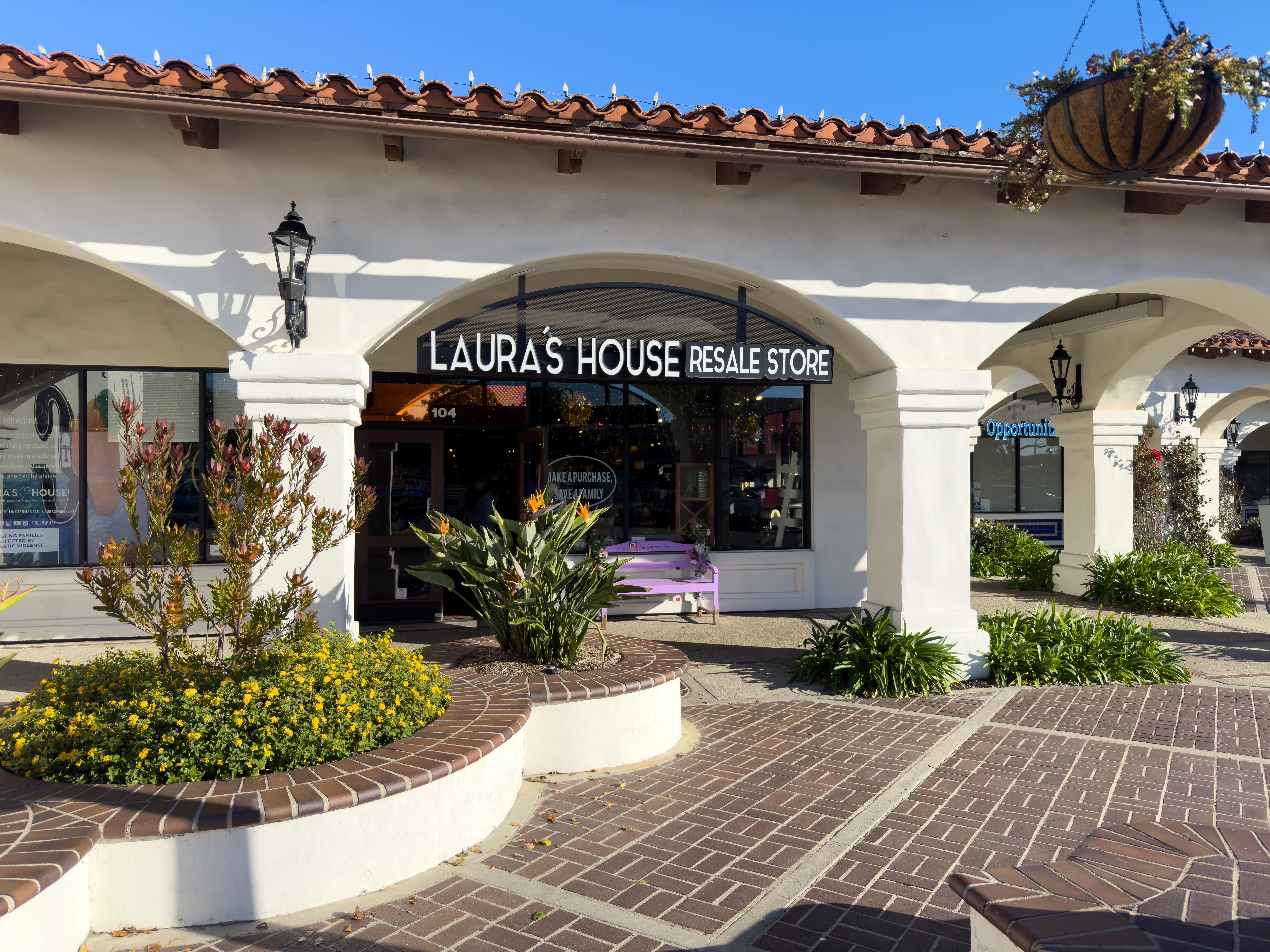warm boutique interior at laura's house resale shop in san juan capistrano with antique wood fixtures