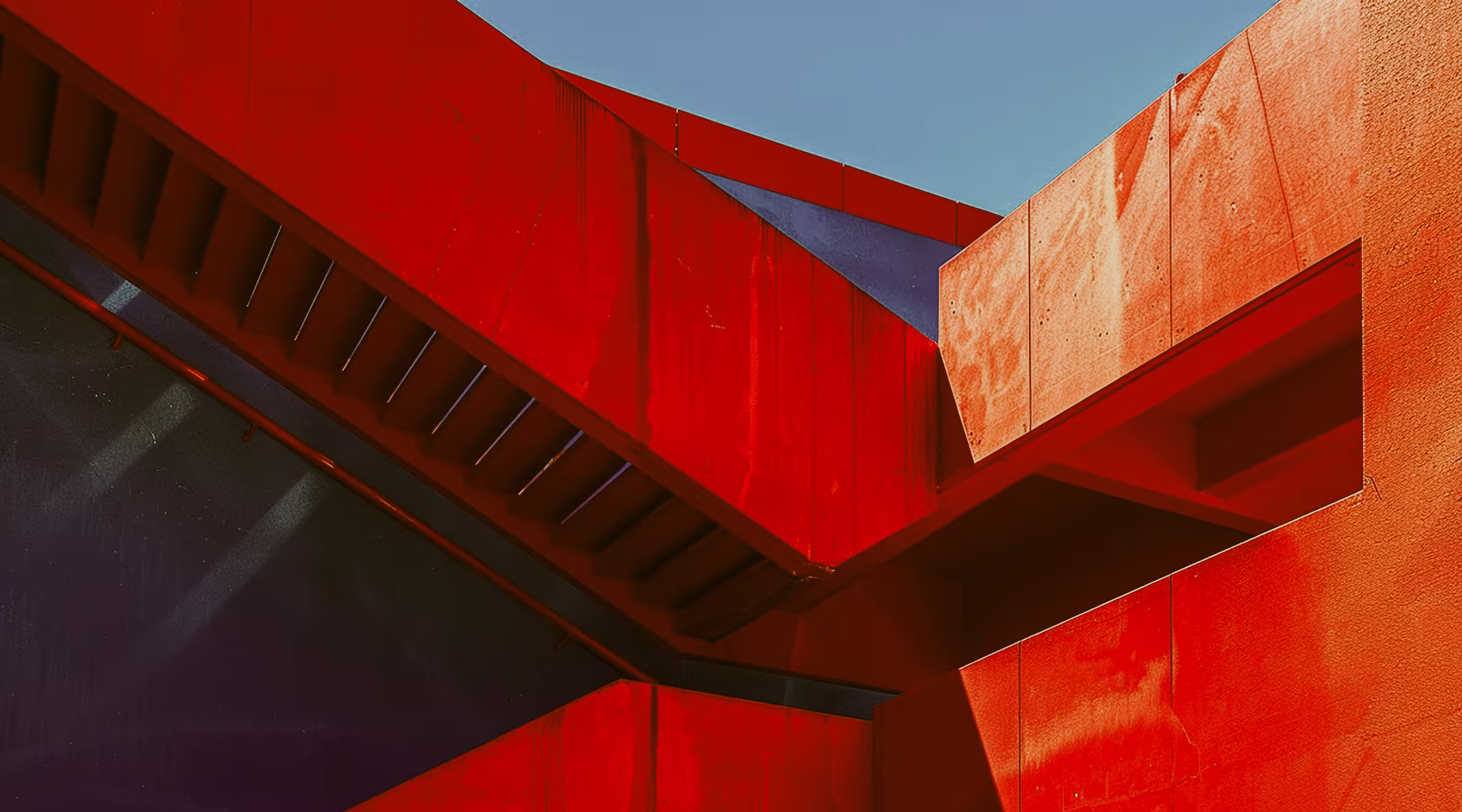 Close-up of vibrant red structural forms and strong lines.