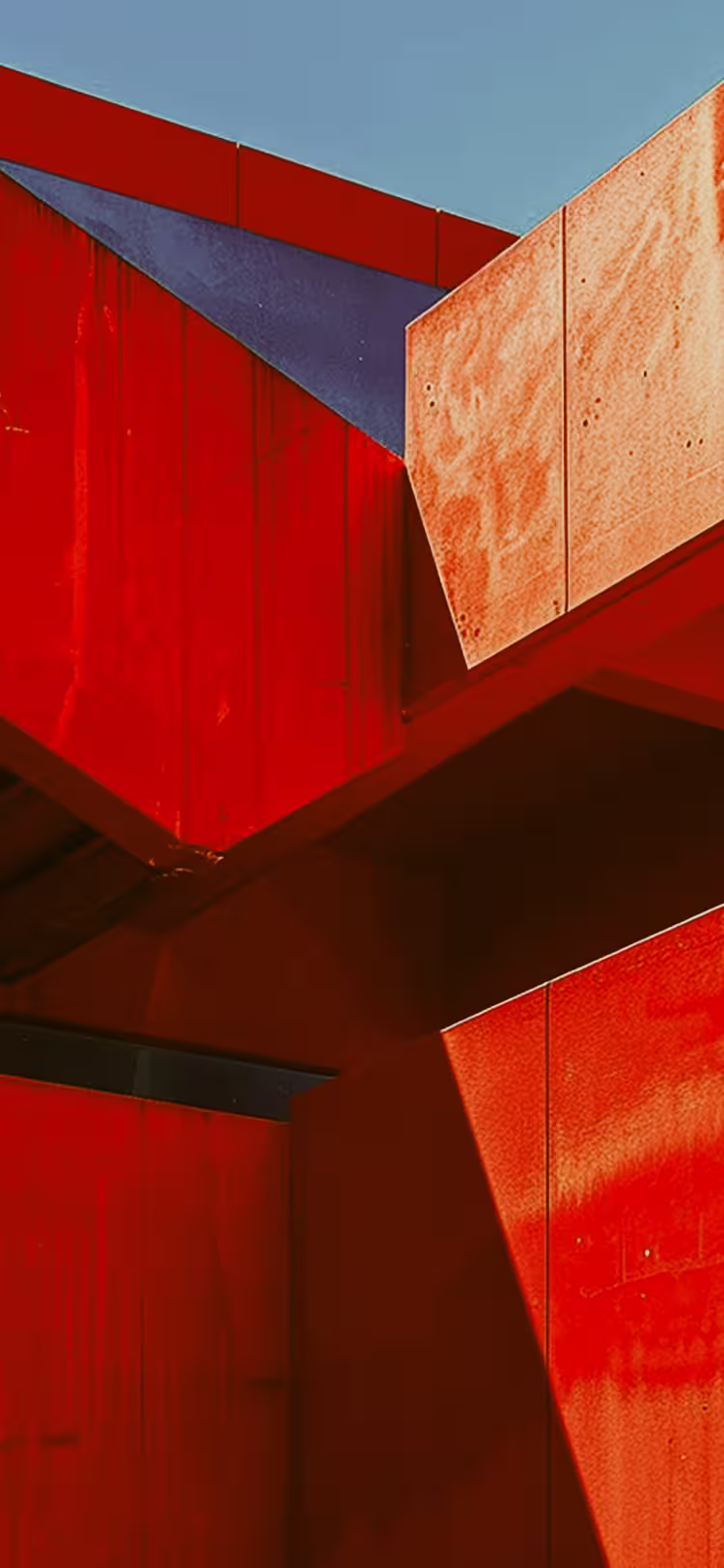 Bold red architectural shapes with sharp angles and contrast.