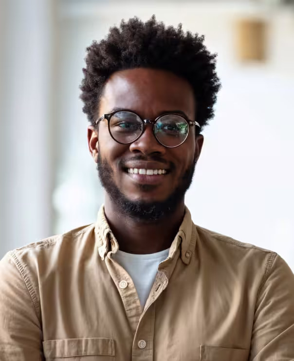 Stylish headshot with glasses and a big smile.