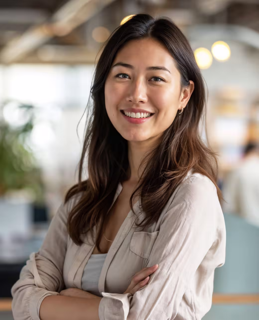 Smiling businesswoman portrait in a bright indoor office setting.