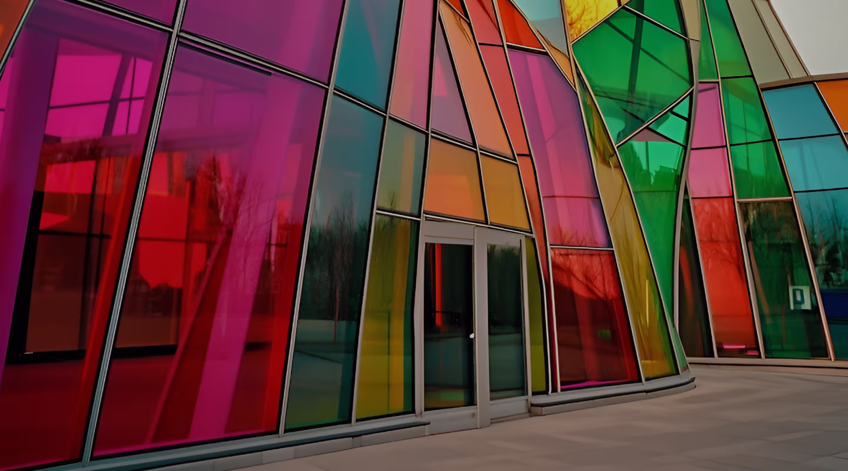 Bright multicolor glass panels forming a rhythmic architectural pattern.