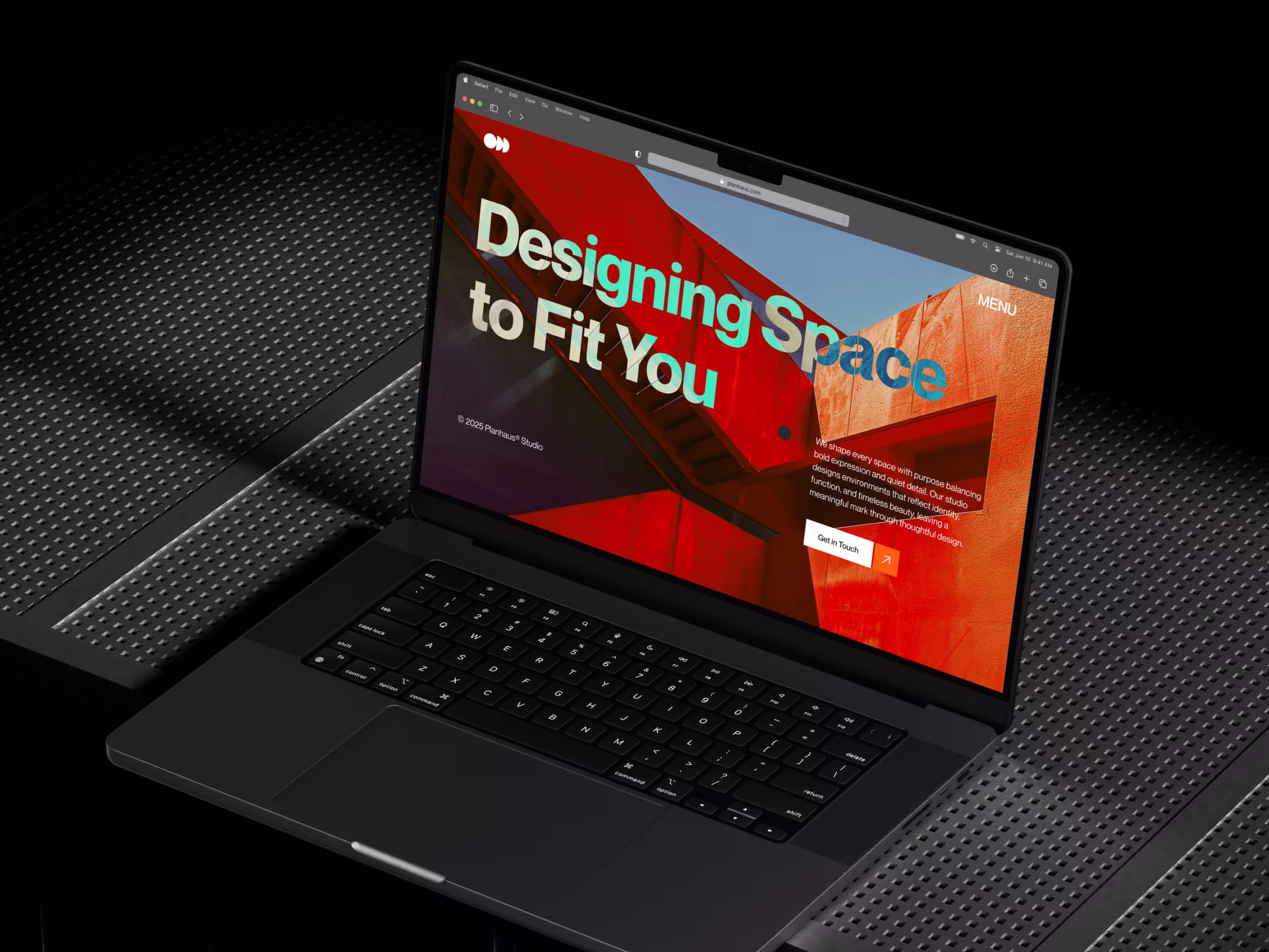 Open laptop on a dark desk showing a bright design slide.