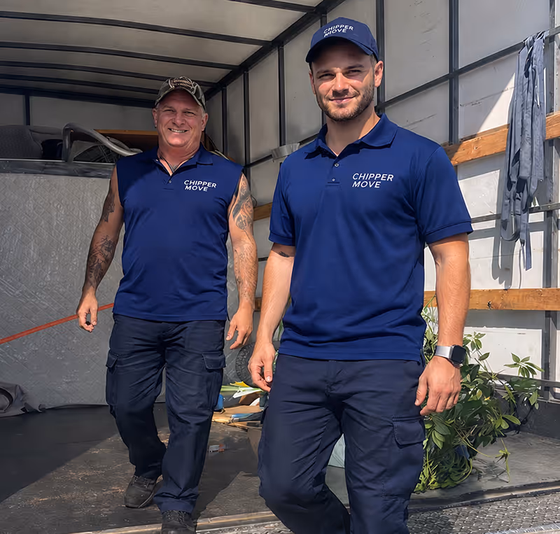 Professional Melbourne removalists from Chipper Move loading furniture into a moving truck outside a suburban home.