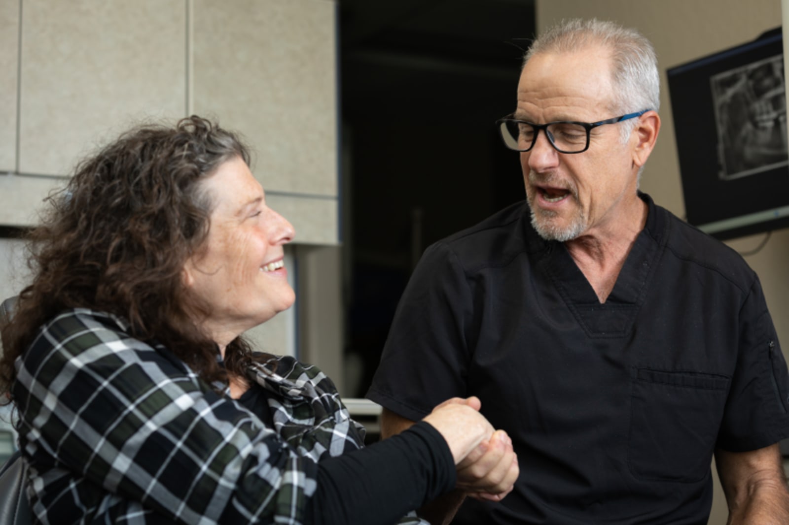 Two dental professionals discuss treatment during a consultation at Smile Haus Dental Studio.