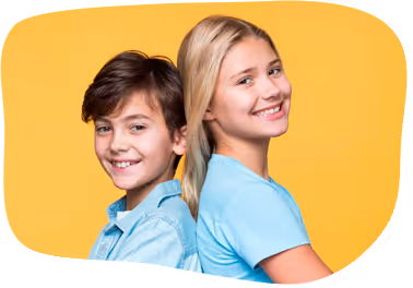 Smiling boy and girl standing back to back against a yellow background.