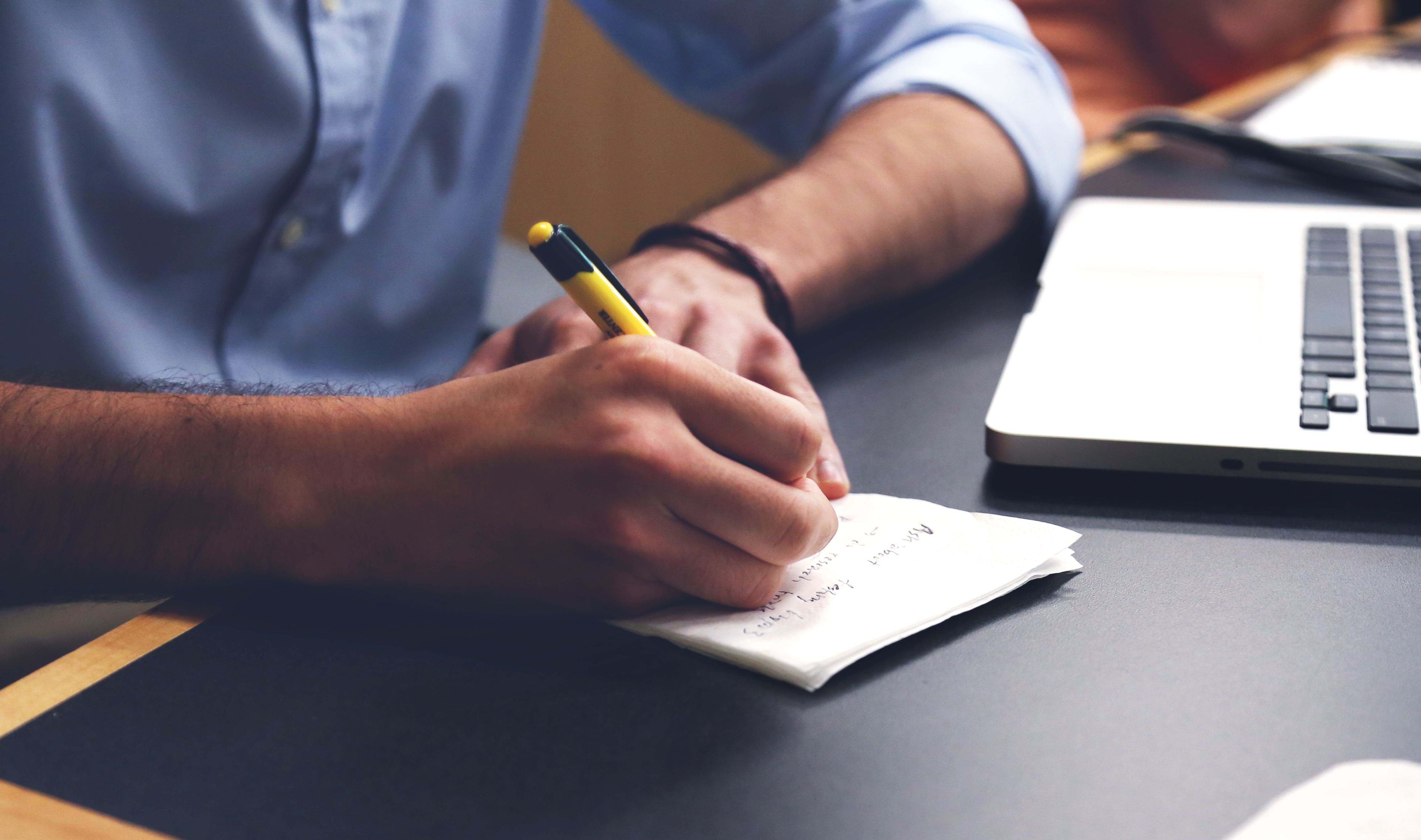 Executive sitting alone with a notebook in a quiet office reflecting