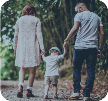 Business Setup in Dubai family walking together on path surrounded by trees