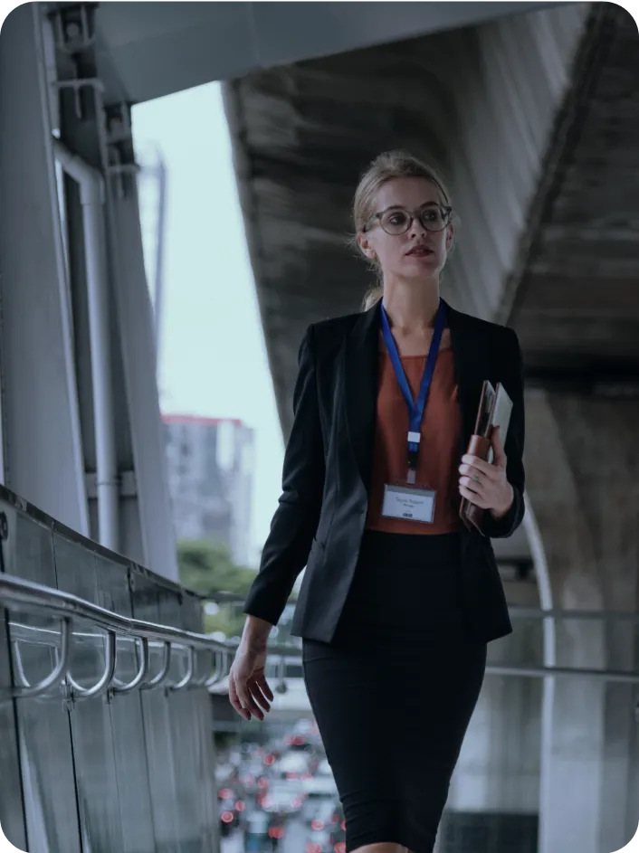 Business Setup in Dubai: Professional walking with documents on urban walkway