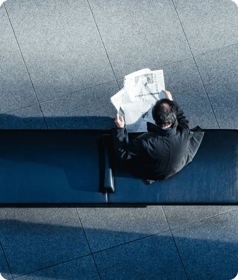 Business Setup In Dubai: Professional reading newspaper in modern office