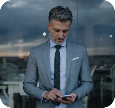 Professional businessman in Dubai Freezone, preparing company setup with smartphone