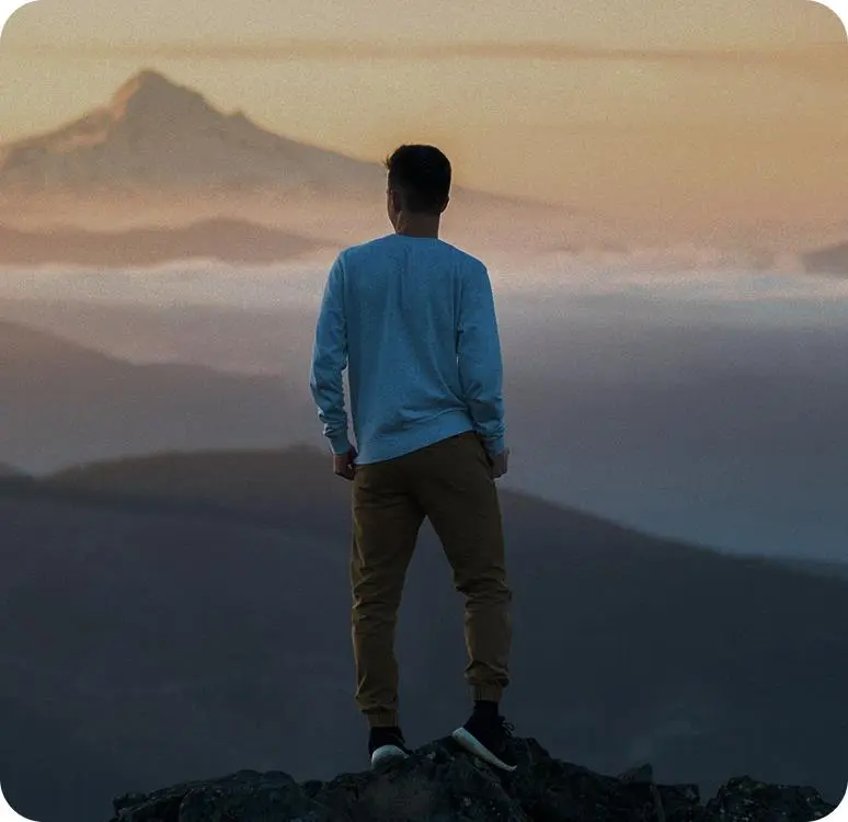 Entrepreneur overlooking misty mountains, symbolizing Freezone Company Setup in Dubai