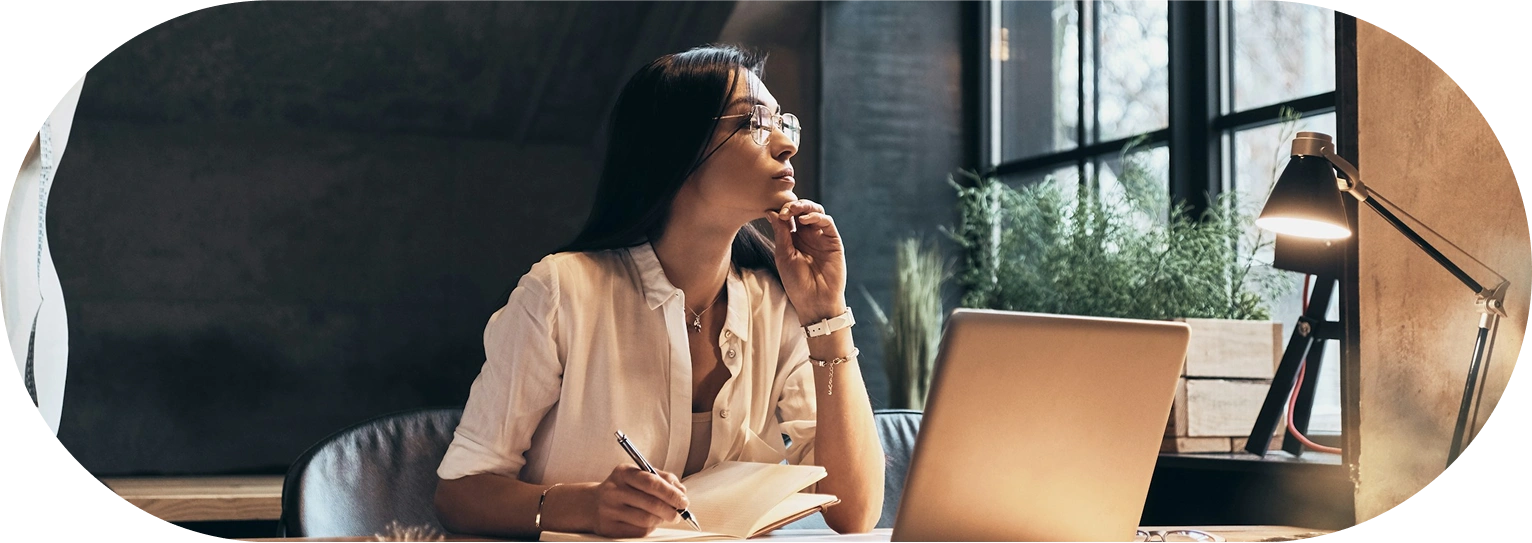 Meydan FZ office decoration with professional working at laptop near window