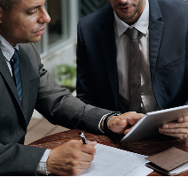 Setting Up A Company In Dubai: Business professionals review documents together