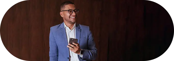 Establish Company In Dubai: Professional businessman smiling with smartphone