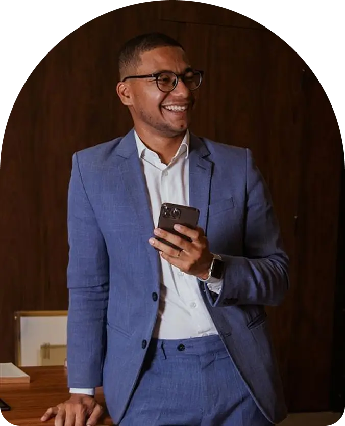 Establish Company In Dubai: Smiling professional in blue suit holding smartphone