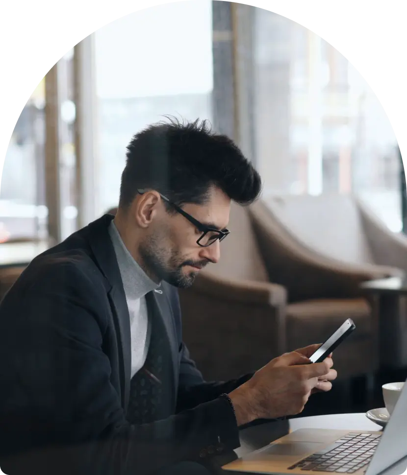 Establish Company In Dubai: Businessman working on phone at office desk