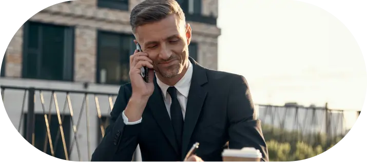Businessman smiling during Company Formation In Dubai phone call outside