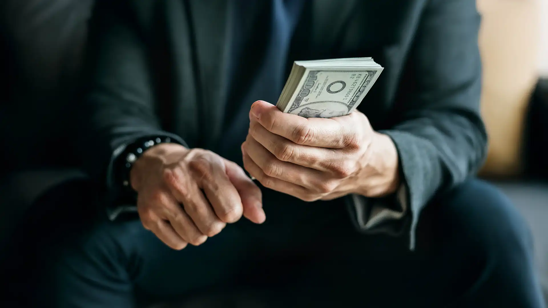 Businessman holding cash stack representing foreign exchange in Dubai financial market