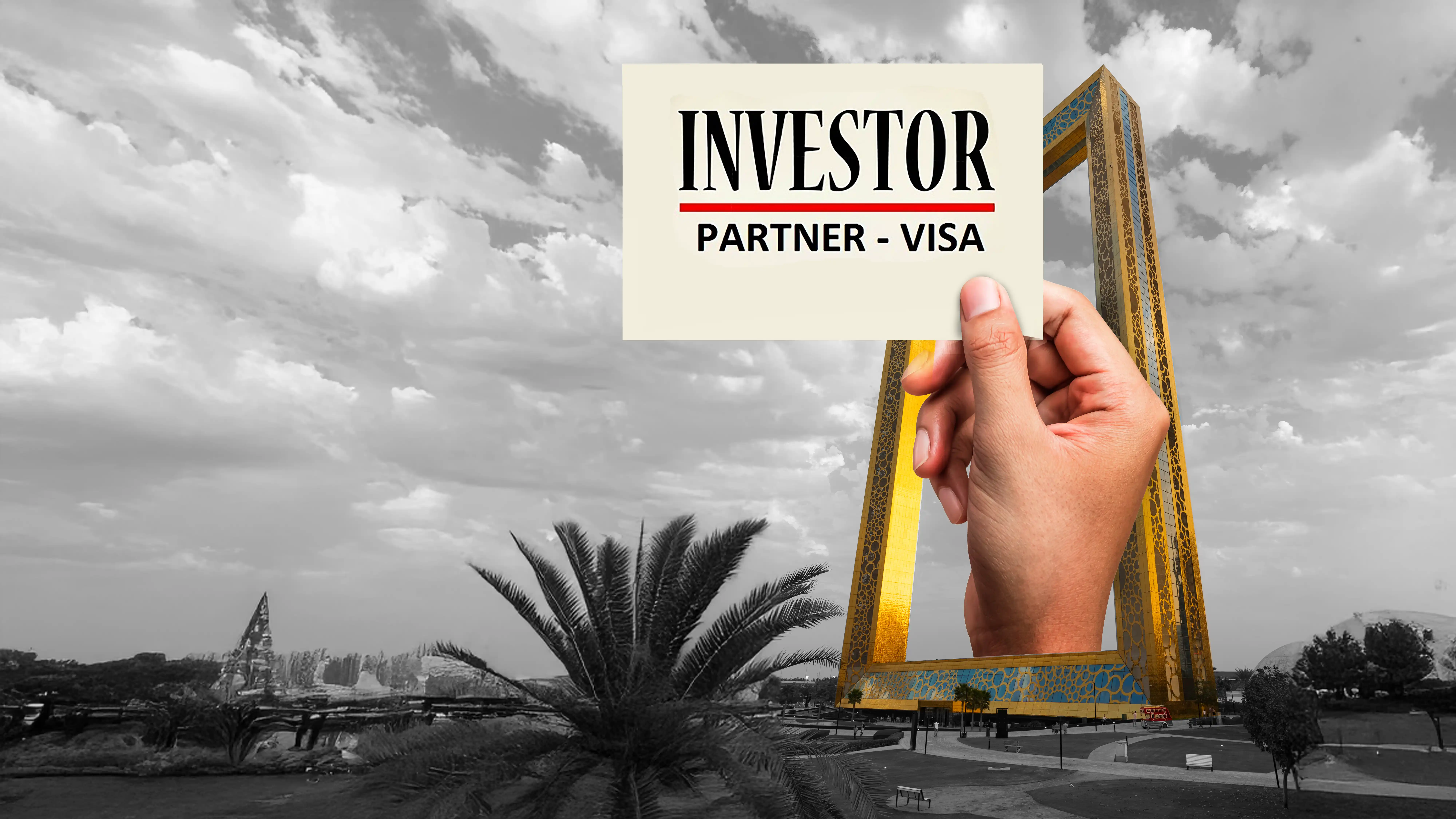Hand holding Dubai Investor Visa card with Dubai Frame in grayscale background, UAE residency program